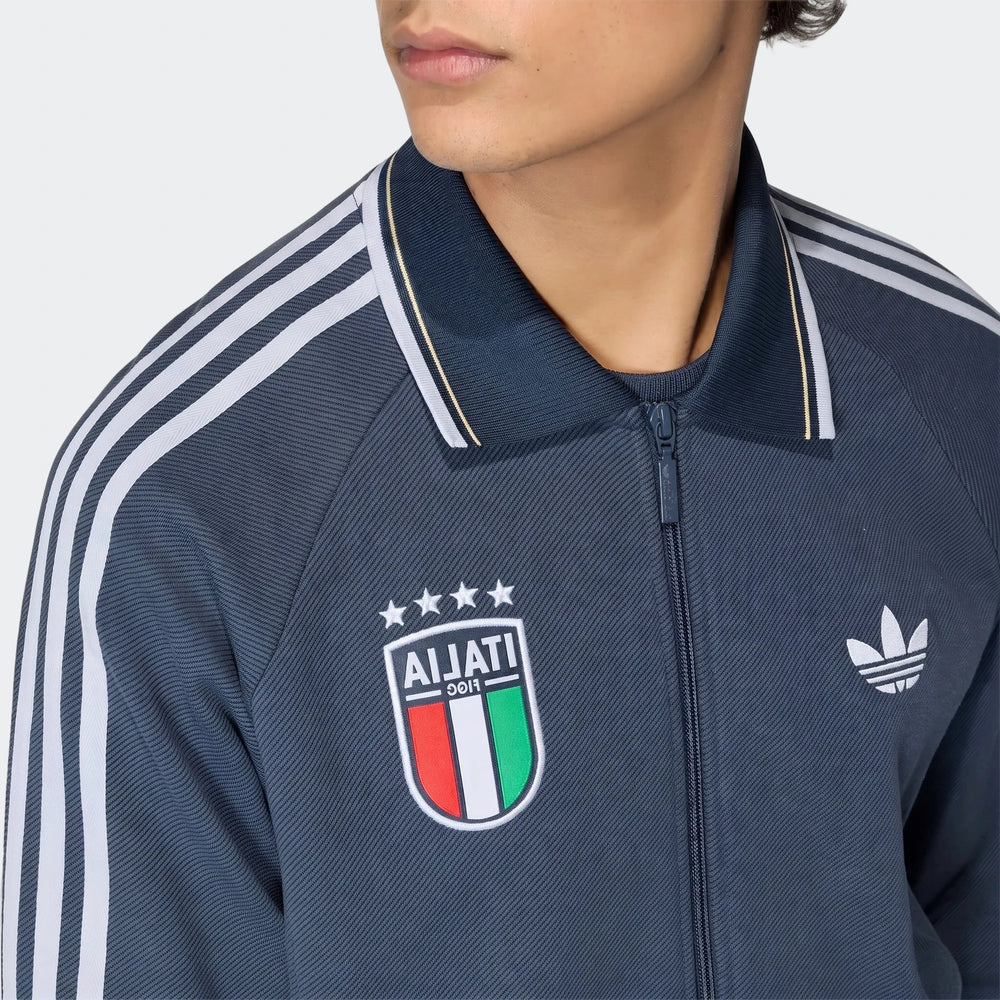 Close-up of a men's navy blue Adidas Italy Away Anthem Jacket, featuring white stripes on the shoulder and a national team
