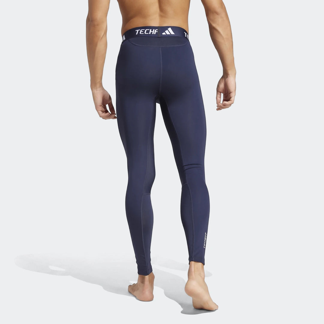 Men's navy compression leggings seen from the back, showcasing the form-fitting design and waistband branding.