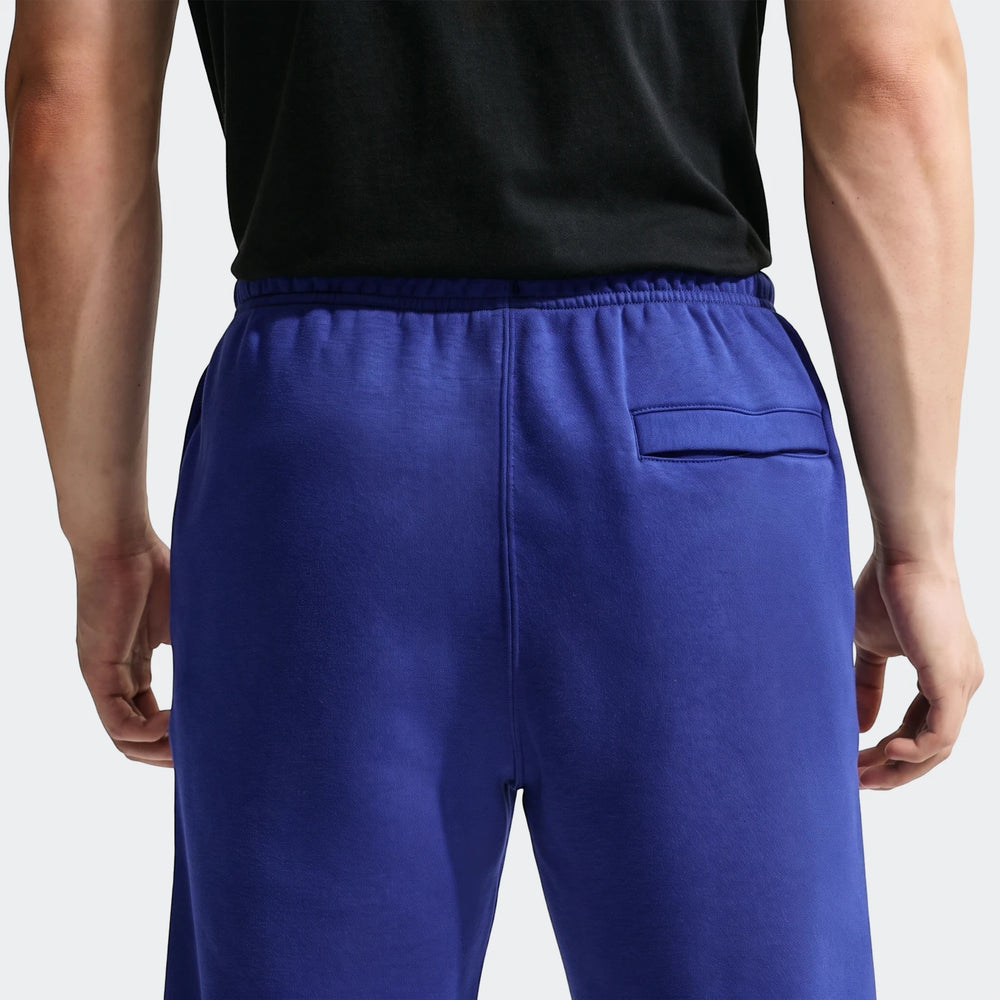 Men's Nike Sportswear Club blue joggers, seen from the back. Features an elasticated waistband and a rear pocket.