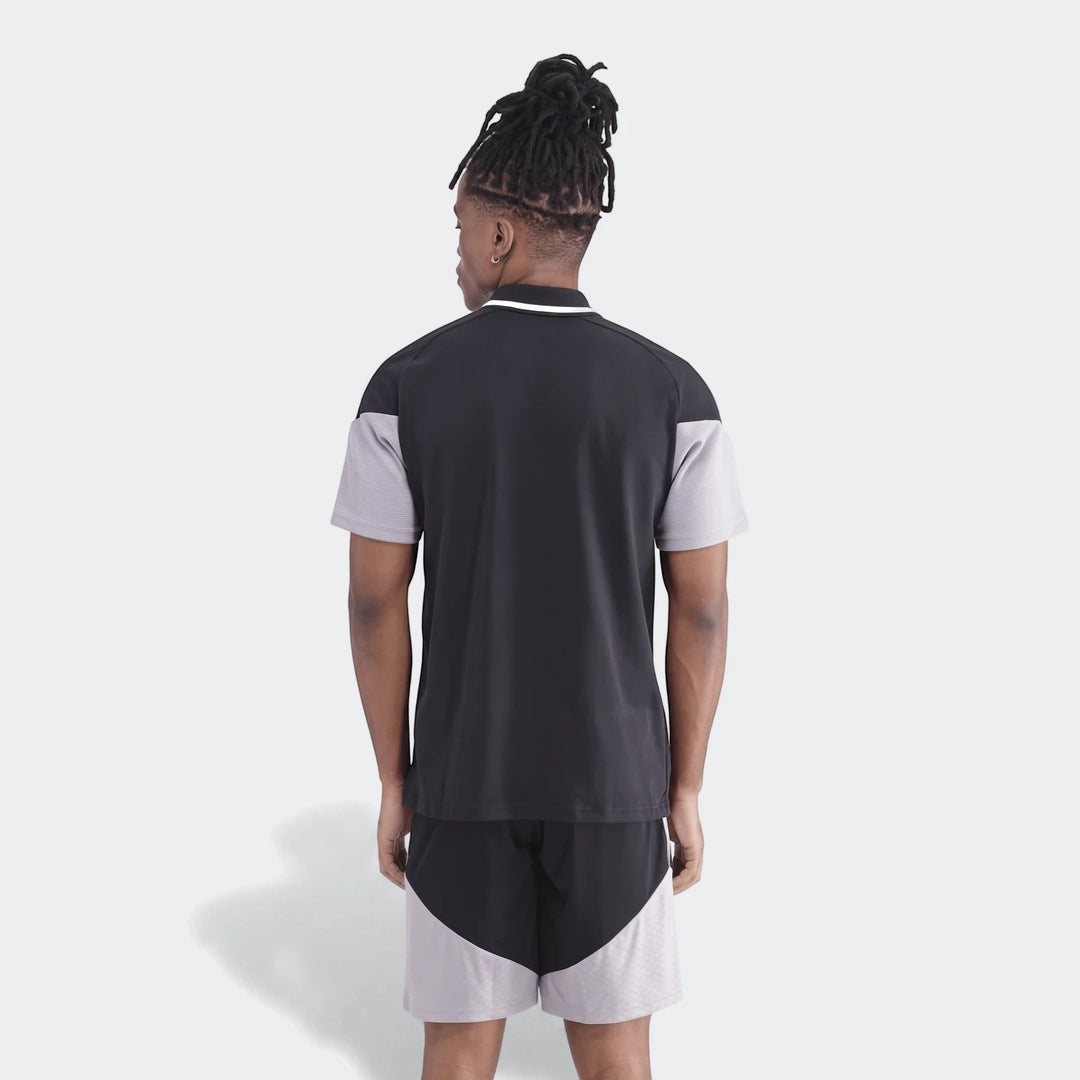 Men's Op Tiro26C Polo in a black and grey color-block design, featuring short sleeves and matching shorts, seen from the