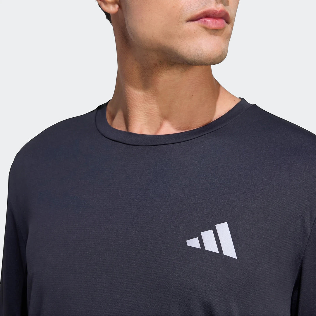 Men's dark Run Essentials Long Sleeve Top, close-up view showing the textured fabric and white Adidas logo.