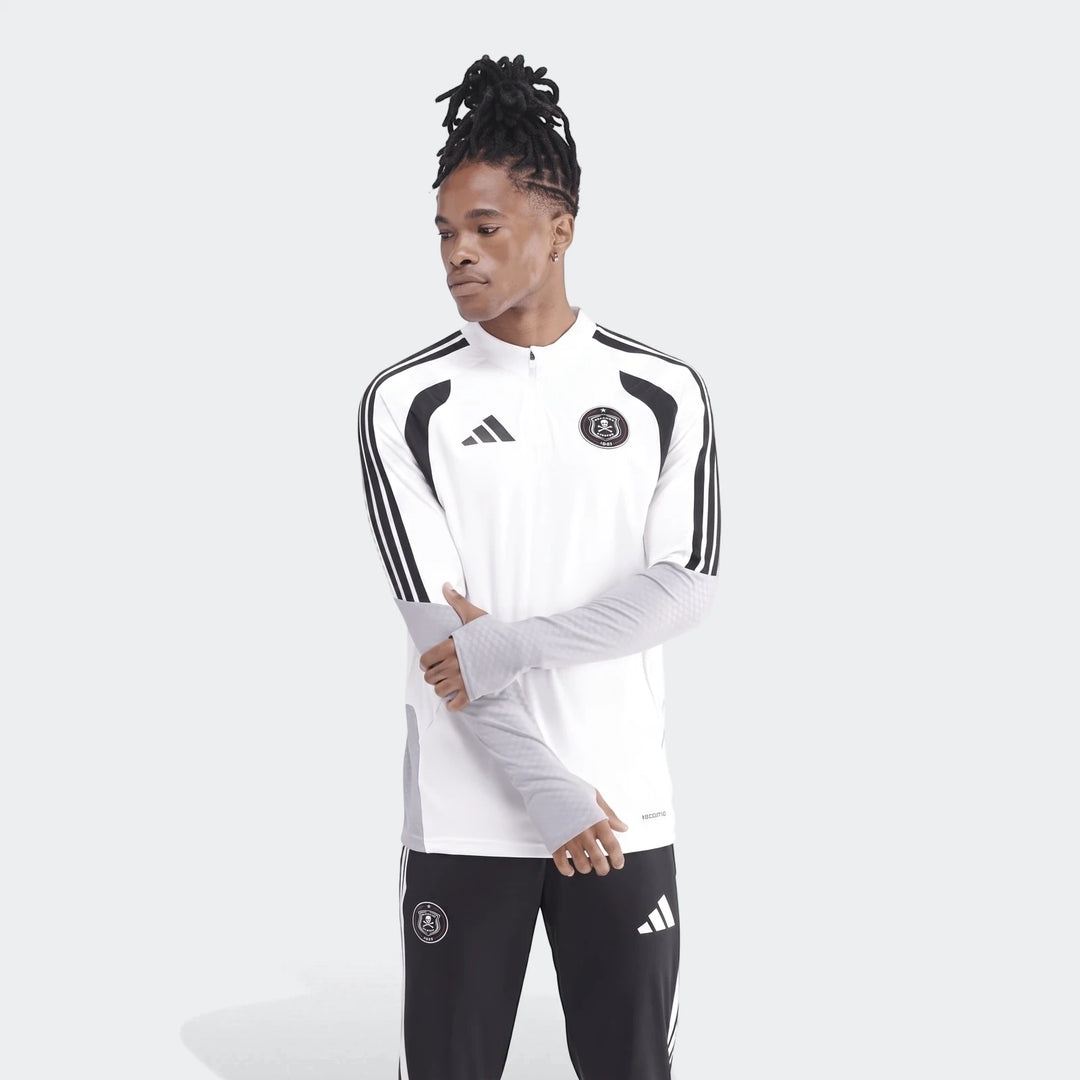 Men's white and black Adidas Op Tiro26C Top with quarter-zip, long sleeves, and club crest, worn by a model with dreadlocks.