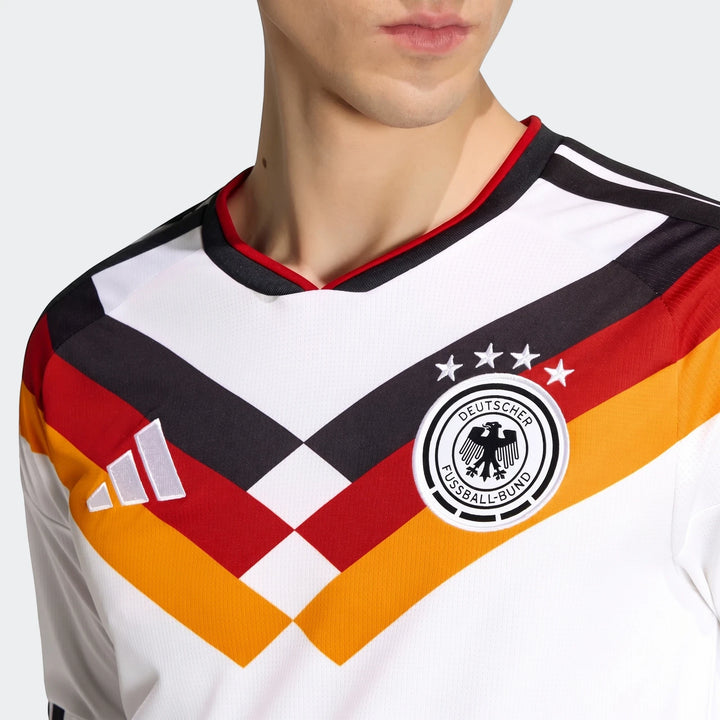 Close-up of a man wearing a white Germany national football team jersey with black, red, and yellow accents and Adidas