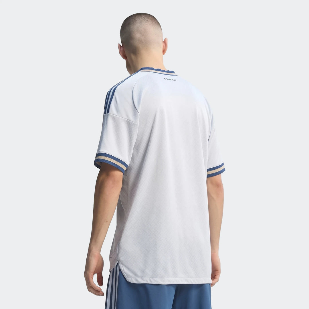 Men's white and light blue Z.N.E. Track Top, short-sleeved, with blue stripes on shoulders and cuffs, worn by a male model,