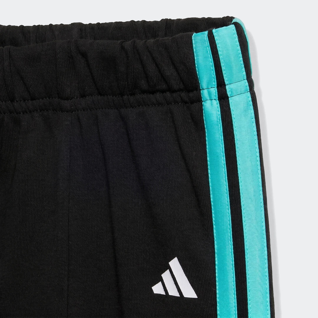 Close-up view of Mercedes-Amg Petronas Formula 1 Team DNA baby jogger set pants, featuring black fabric with turquoise side
