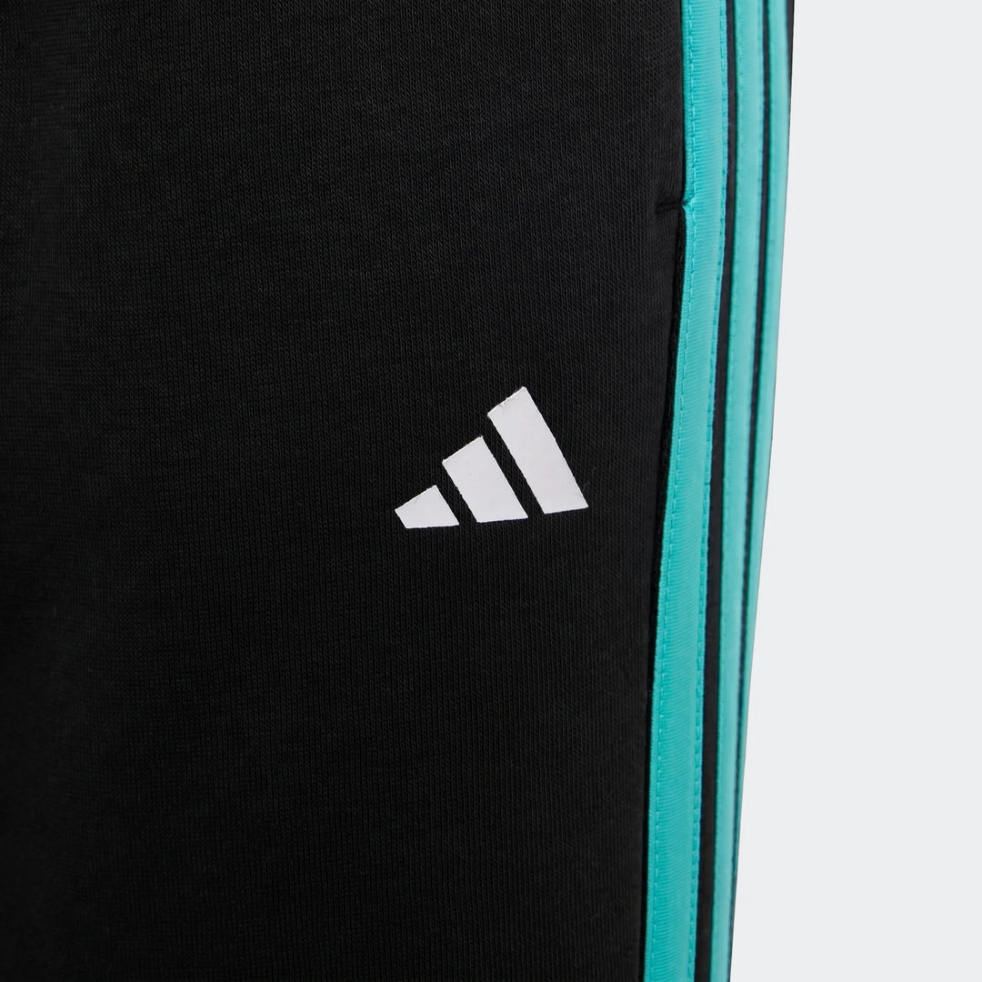 Close-up of kids' Mercedes-AMG Petronas Formula 1 Team DNA Pants in black with white Adidas logo and teal side stripes.