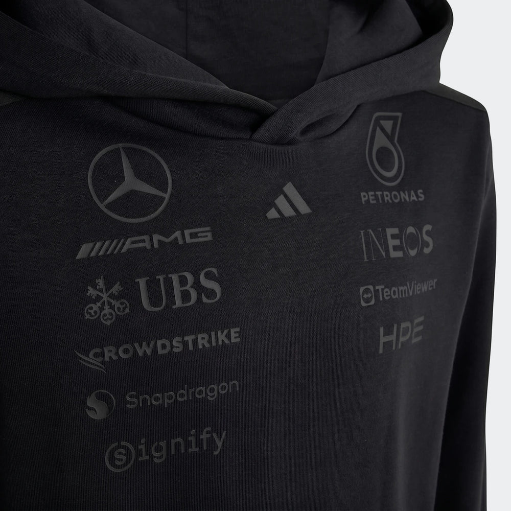 Close-up of a black Mercedes-AMG Petronas Formula 1 Team Night Driver Youth Hoodie, featuring various sponsor logos.