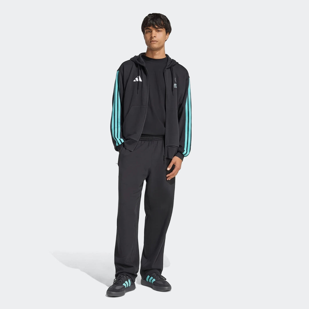 Male model wearing a black Mercedes-Amg Petronas Formula 1 Team Dna Full-Zip Hoodie with teal stripes, black track pants,
