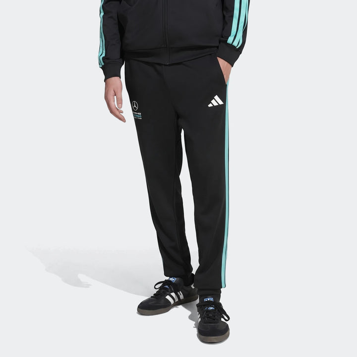 Mercedes-Amg Petronas Formula 1 Team Dna Pants for men, black with light blue side stripes, worn with black sneakers.