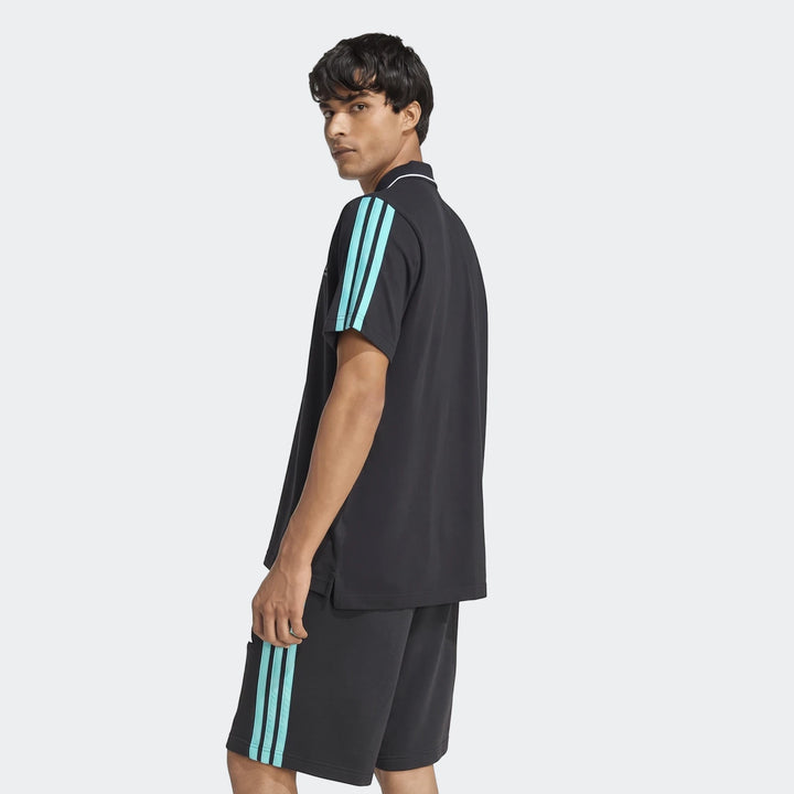 Male model wearing a black Mercedes-Amg Petronas Formula 1 Team Dna Polo Shirt with light blue stripes, side view.