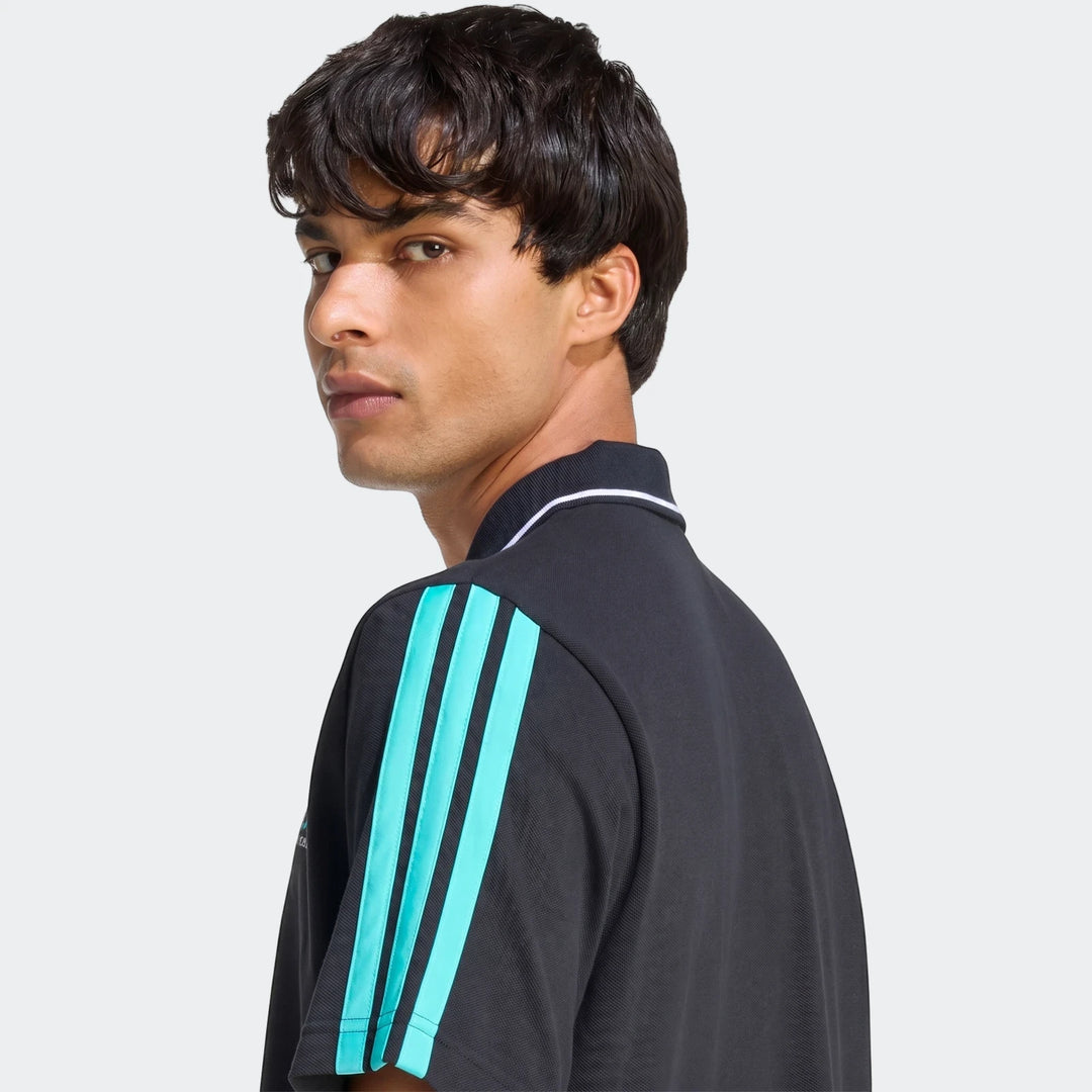 Men's black Mercedes-AMG Petronas Formula 1 Team DNA polo shirt with cyan stripes on sleeve, worn by a model looking over
