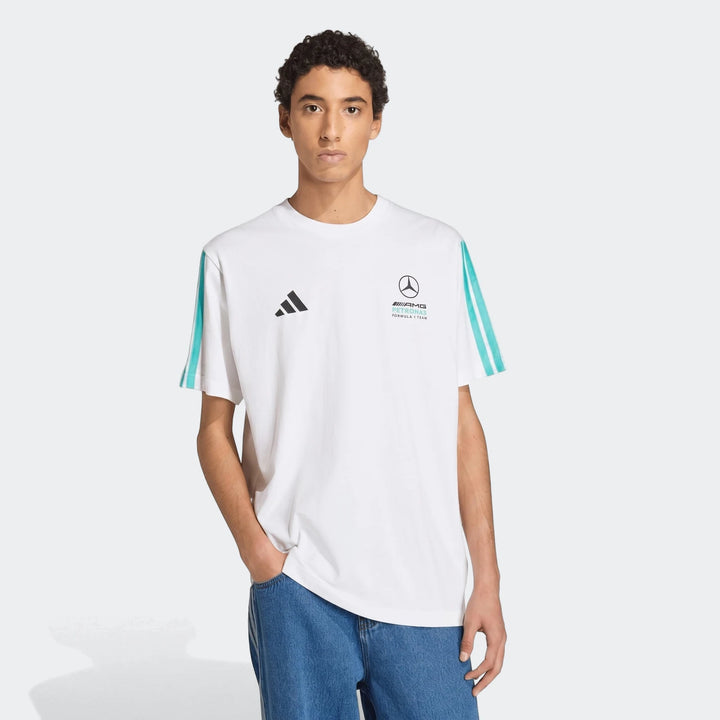 Male model wearing a white Mercedes-AMG Petronas Formula 1 Team DNA T-Shirt featuring turquoise stripes and brand logos.