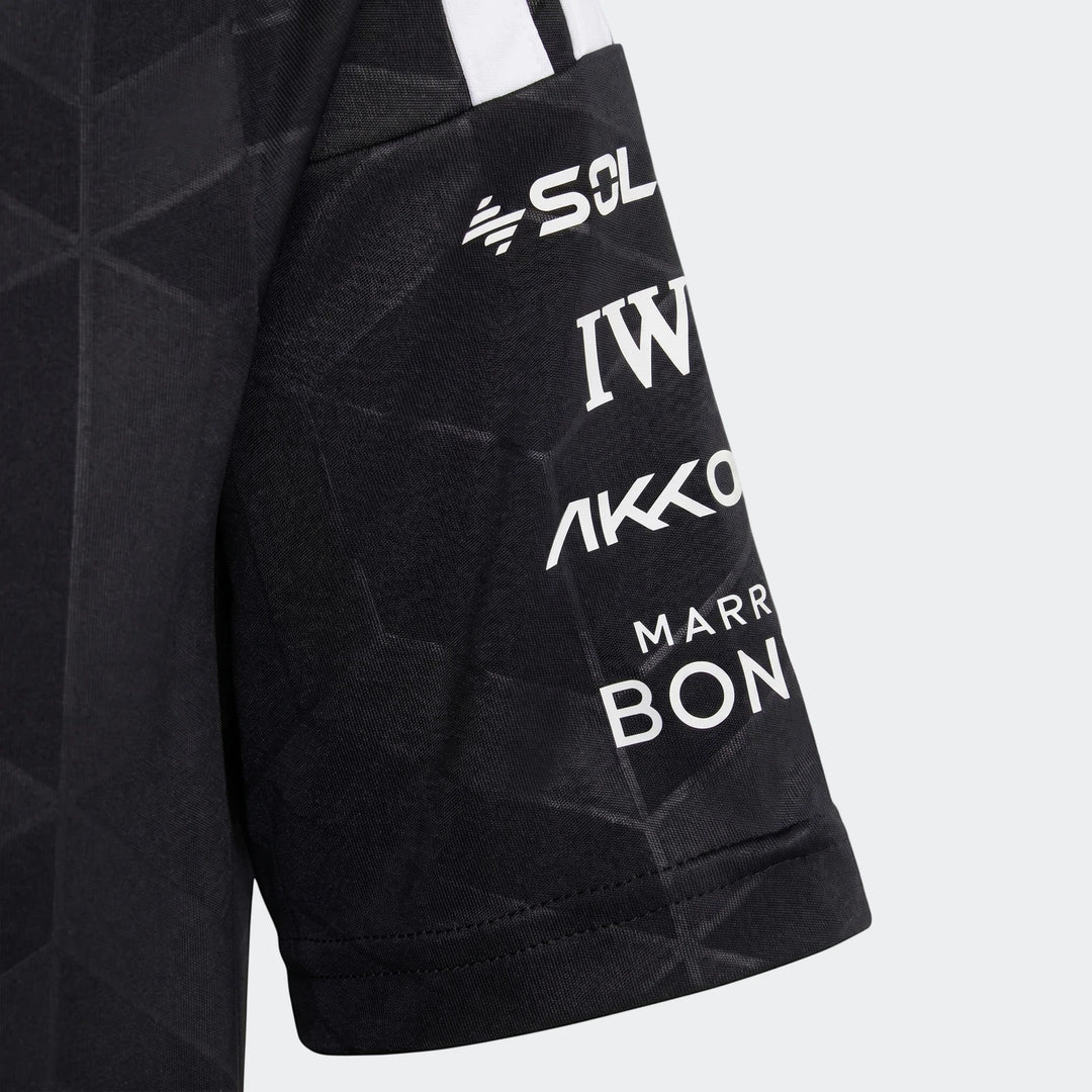 Close-up of a black Mercedes-AMG Petronas Formula 1 Team Driver Youth jersey sleeve, featuring white sponsor logos and team