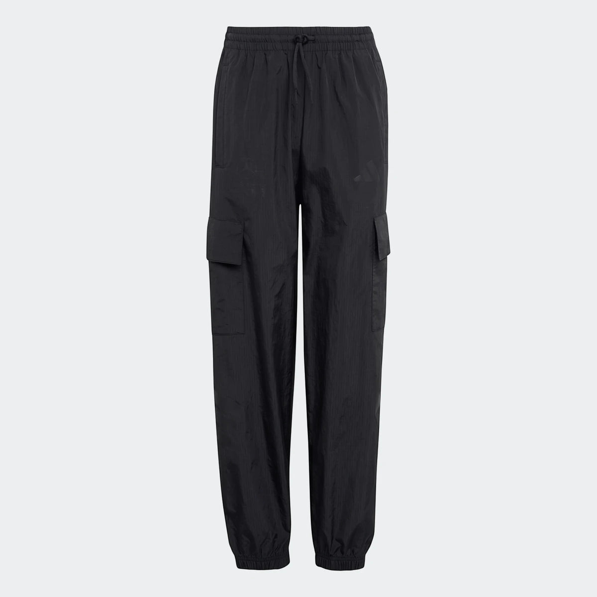 Black Mercedes-AMG Petronas Formula 1 Team Youth woven pants with cargo pockets on a studio background.