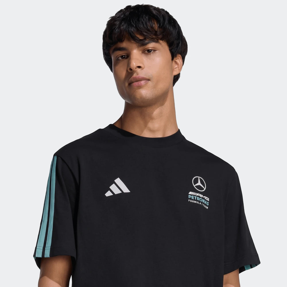 Young man wearing a black Mercedes-AMG Petronas Formula 1 Team DNA T-Shirt with white logos and teal stripes.