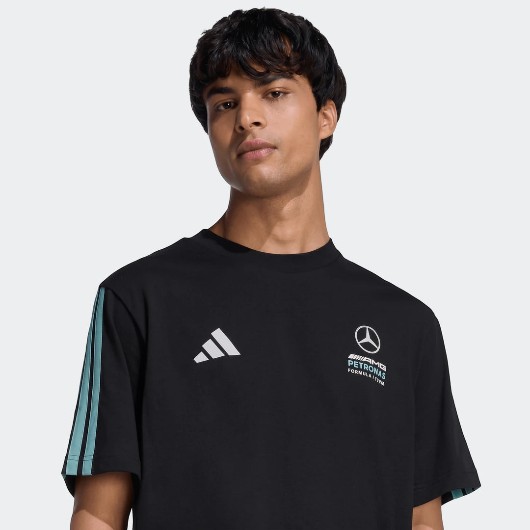 Young man wearing a black Mercedes-AMG Petronas Formula 1 Team DNA T-Shirt with white logos and teal stripes.