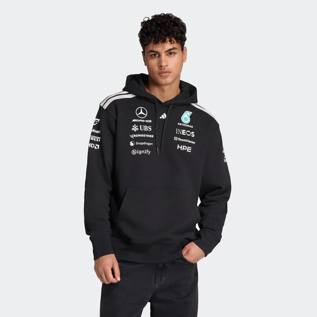 Black Mercedes-Amg Petronas Formula 1 Team Driver Hoodie worn by a man, detailed with sponsor logos.