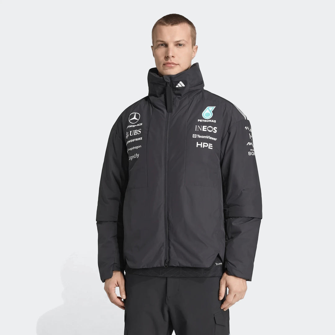 Black Mercedes-AMG Petronas Formula 1 Team Energy Jacket worn by a man, featuring sponsor logos and a high collar.