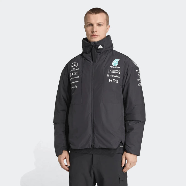 Black Mercedes-AMG Petronas Formula 1 Team Energy Jacket worn by a man, featuring sponsor logos and a high collar.