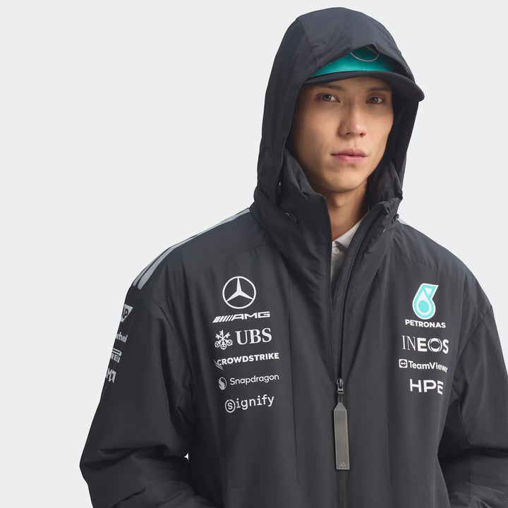 Male model wearing a black Mercedes-AMG Petronas Formula 1 Team Energy Jacket, featuring multiple team and sponsor logos.