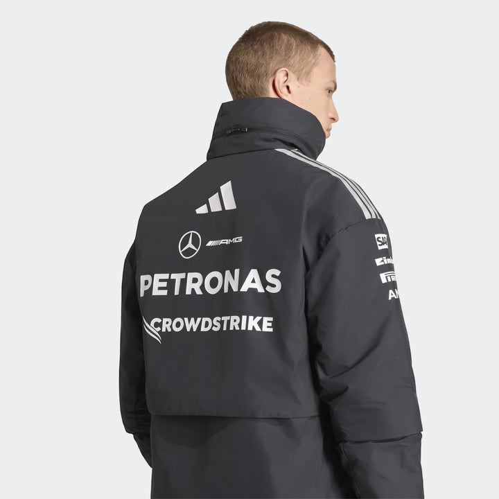 Dark gray Mercedes-AMG Petronas Formula 1 Team Energy Jacket, worn by a male model and showcasing team and sponsor logos on