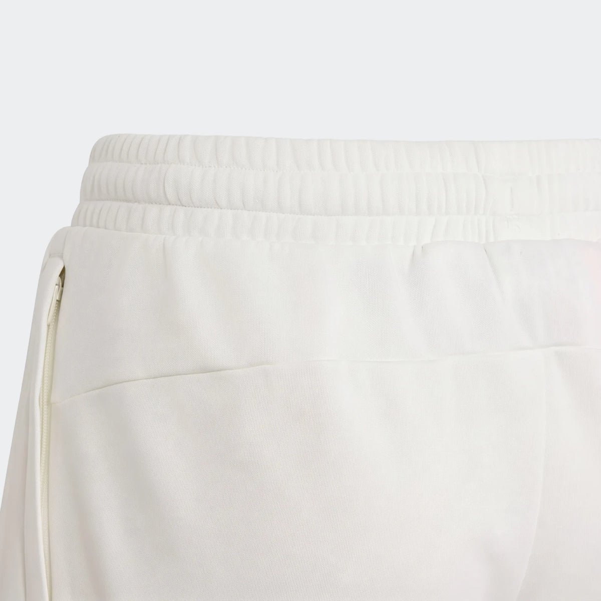 Close-up of white Adidas Messi House Of Tiro Kids Shorts showing the elastic waistband, fabric texture, and side zipper