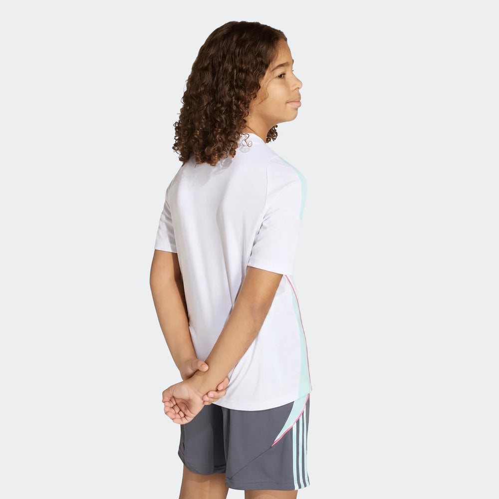 Youth boy wearing a white short-sleeve Messi Training Jersey and grey shorts, posed from the waist up against a plain