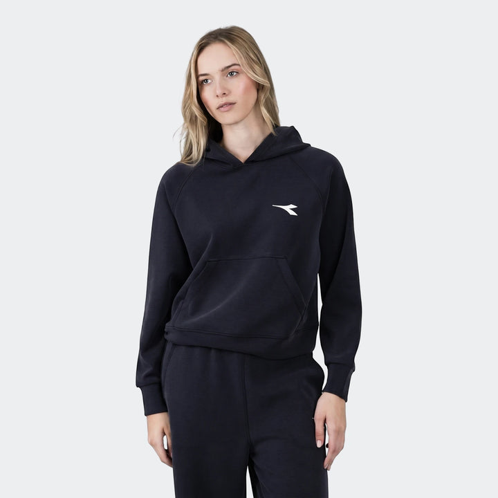Woman wearing a navy blue Michelle Hoodie and matching sweatpants, styled casually for comfort.