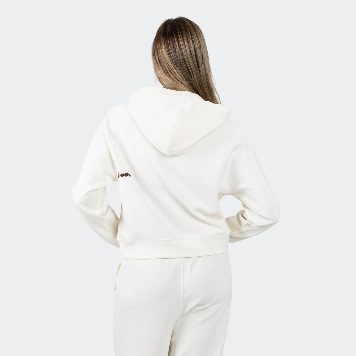 Female model from back wearing an off-white Michelle Hoodie and matching sweatpants, showcasing casual loungewear.