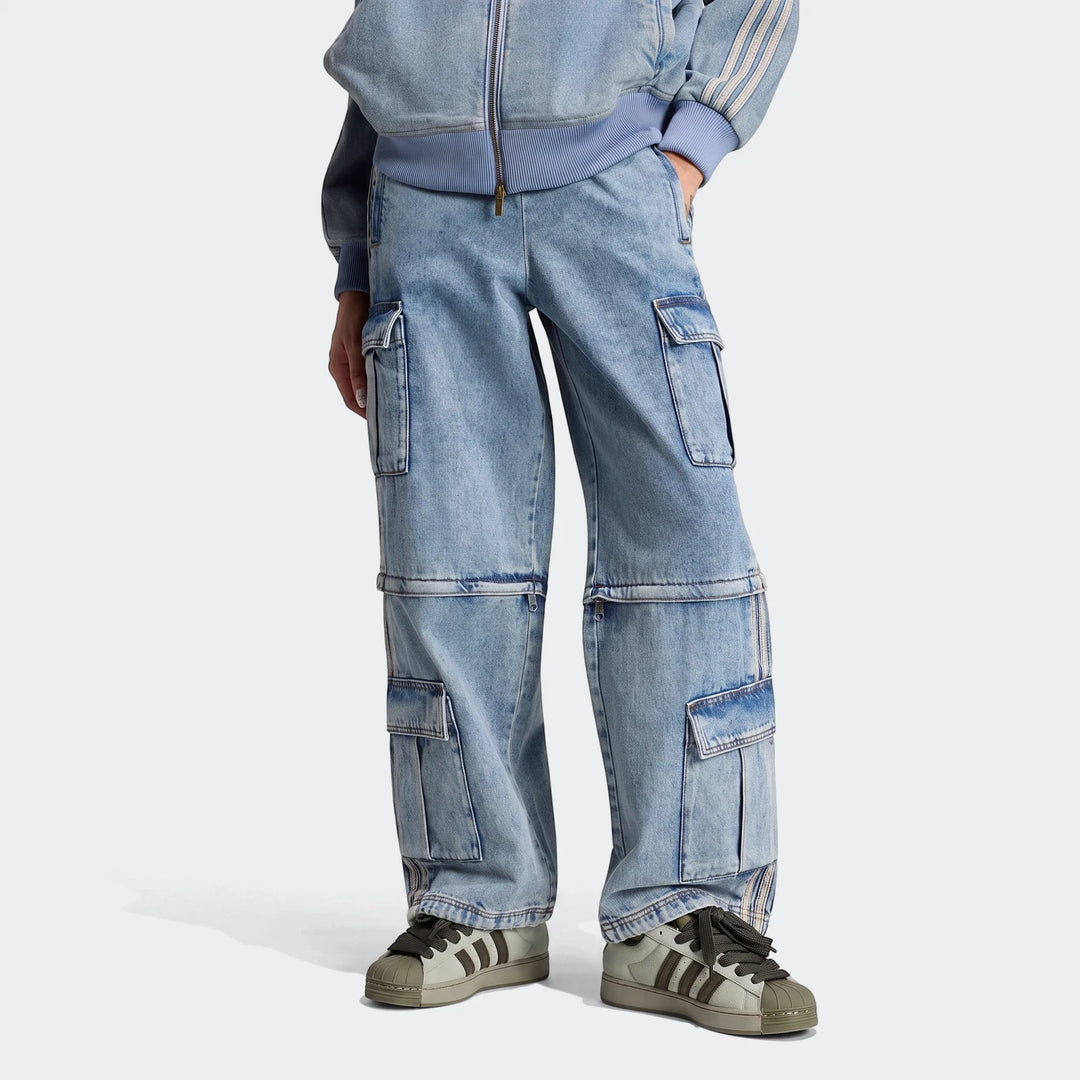 Model wears light-wash mid-rise 2-in-1 denim cargo pants with convertible knee zippers and two-tone sneakers.