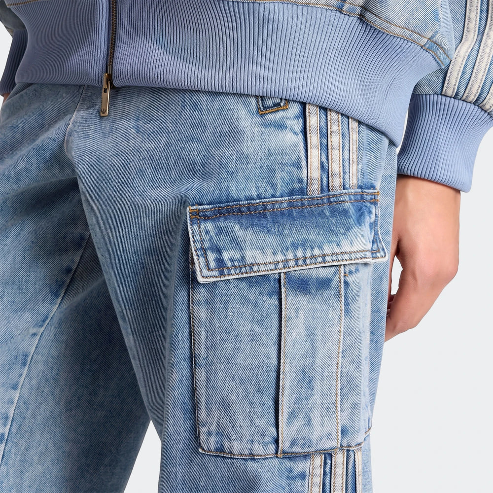 Close-up of a person wearing light blue Mid-Rise 2-In-1 Denim Pants with cargo pockets and a matching ribbed jacket.
