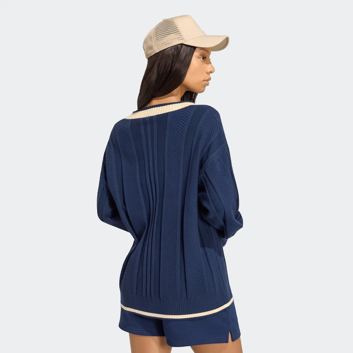 Navy blue Cable Knit Cardigan with cream trim, worn by a model from the back, paired with matching shorts and a beige mesh