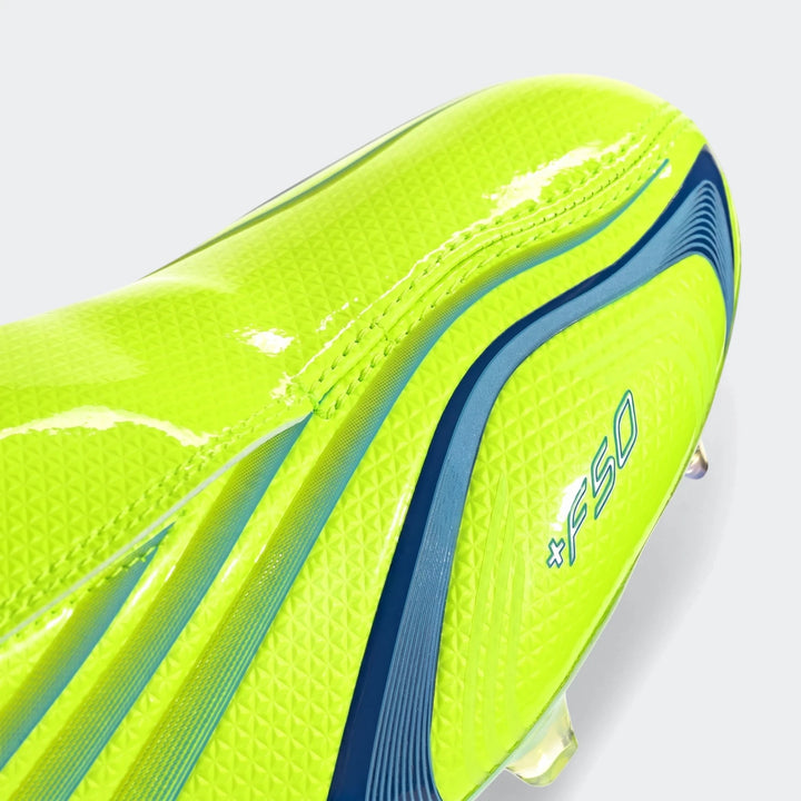 Close-up of a neon yellow-green soccer cleat featuring dynamic blue stripes and an F50 logo on a studio background.