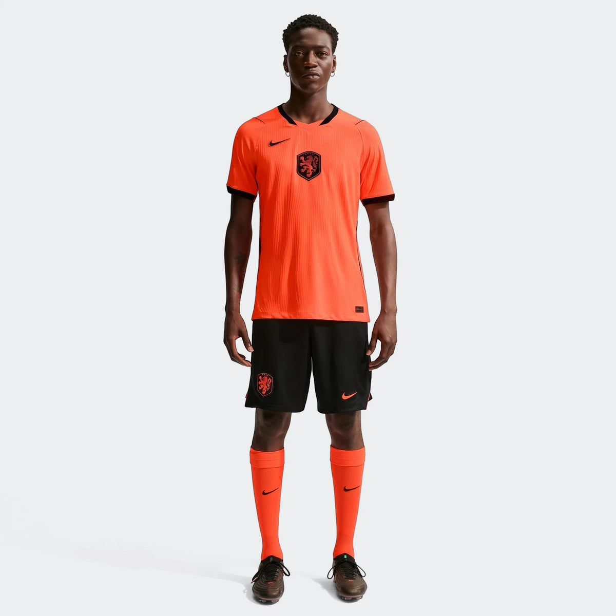 Netherlands National Team 2026 Match Home Orange Men's Nike Aero-Fit Soccer Jersey on a model, full body view.