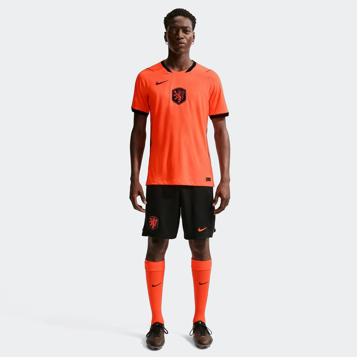 Netherlands National Team 2026 Match Home Orange Men's Nike Aero-Fit Soccer Jersey on a model, full body view.