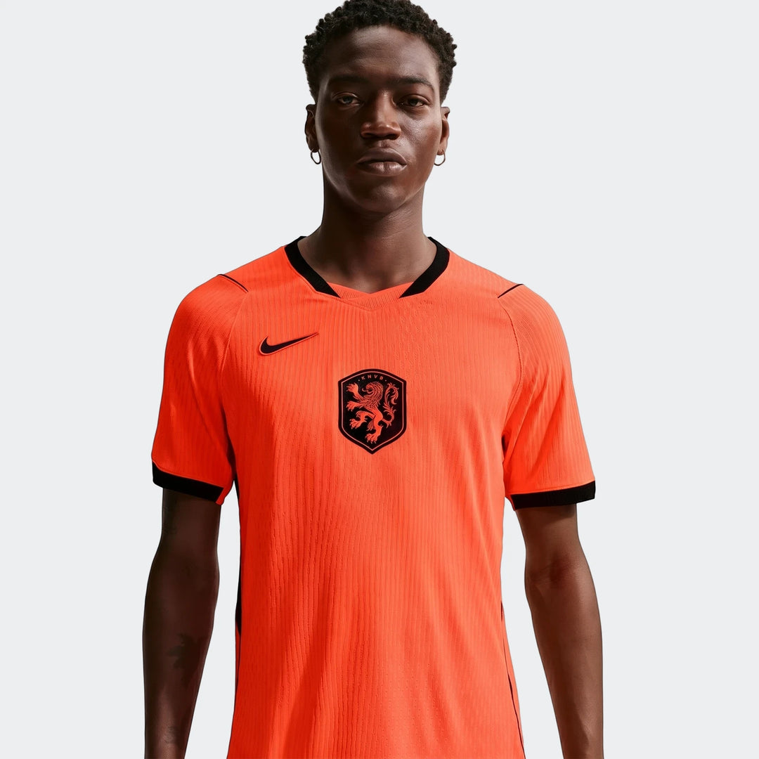 Netherlands National Team 2026 Match Home Orange Men's Nike Aero-Fit Soccer Jersey worn by a model, chest up view.