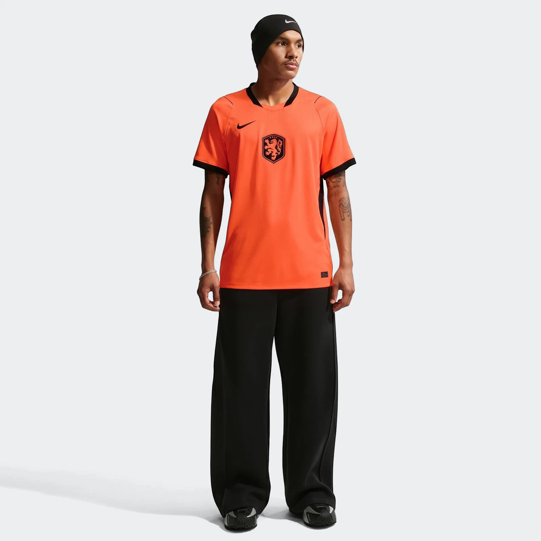 Orange Nike Dri-Fit Netherlands National Team 2026 Stadium Home men's soccer jersey on a model, full body view.