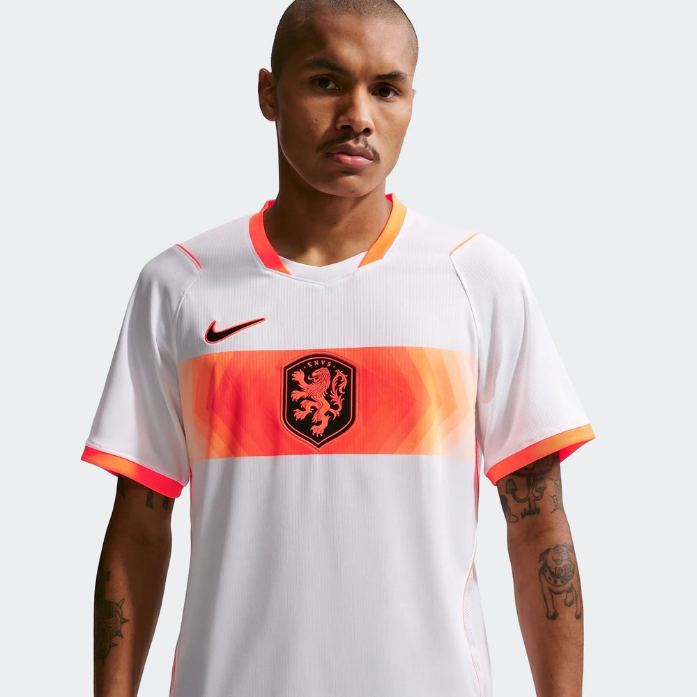 A male model wears the Netherlands National Team 2026 Stadium Away White Nike Dri-Fit Soccer Jersey, featuring orange