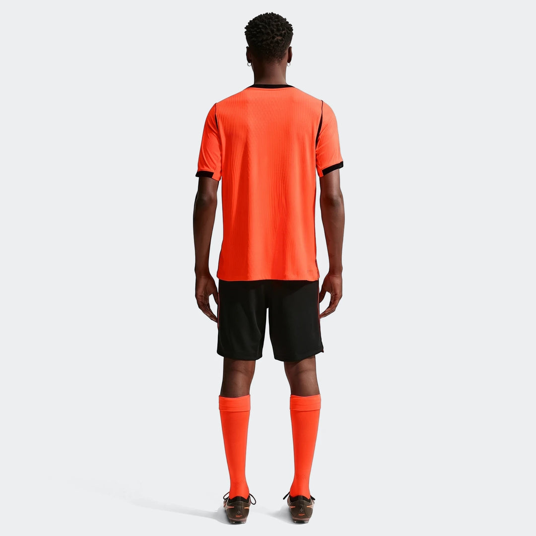 Men's Nike Aero-Fit Netherlands National Team 2026 Match Home Soccer Jersey in orange, worn by a model from the back,