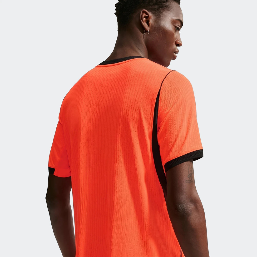 Men's Netherlands National Team 2026 Match Home Nike Aero-Fit Soccer Jersey in vibrant orange, worn by a model from the back.