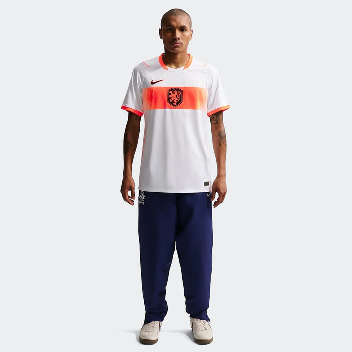 Netherlands National Team 2026 Stadium Away White Men's Nike Dri-Fit Soccer Jersey worn by a model with navy blue pants and