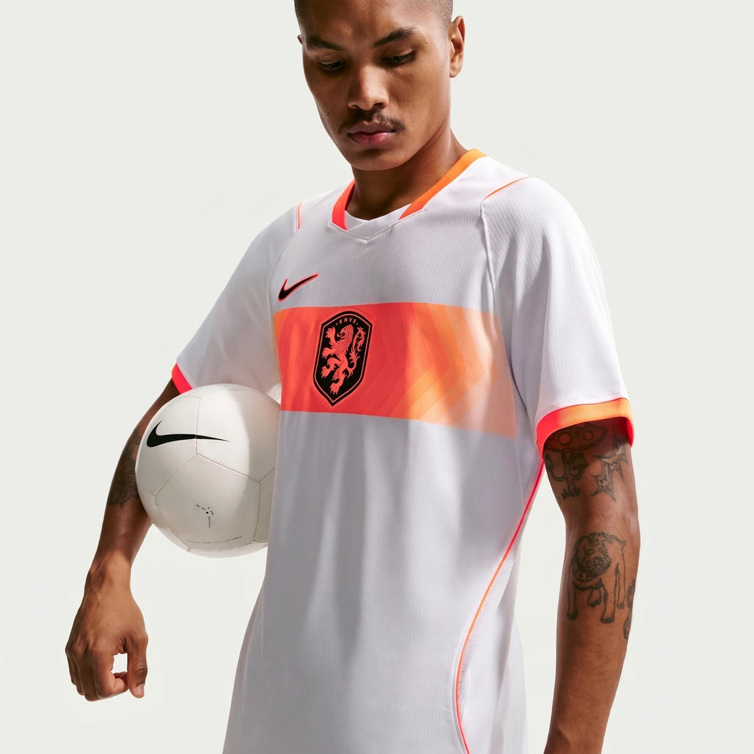 Netherlands National Team 2026 Stadium Away White Men's Nike Dri-Fit Soccer Jersey shown on a male model holding a white