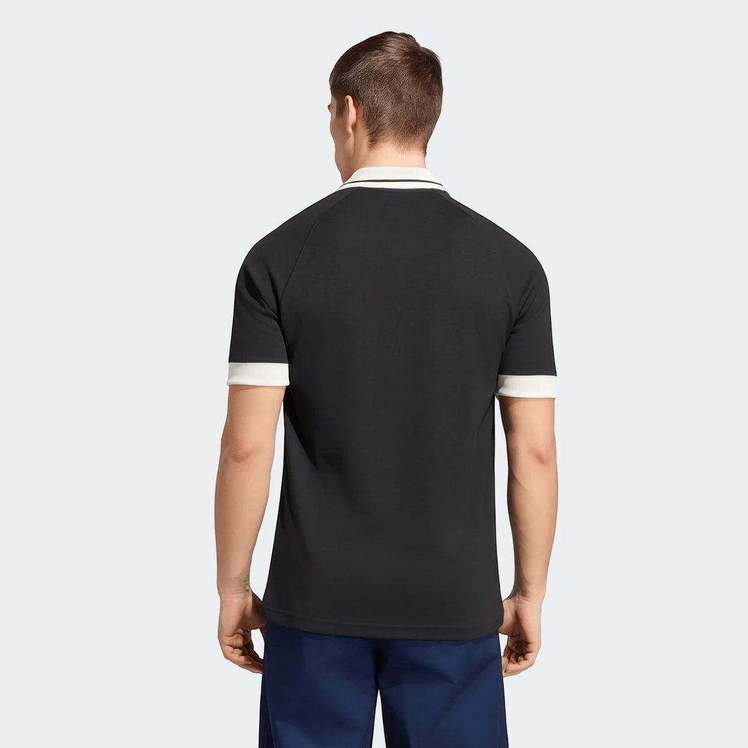 New Zealand Rugby Leisurewear Polo Shirt in black with a white collar and striped cuffs, shown from the back on a male model.