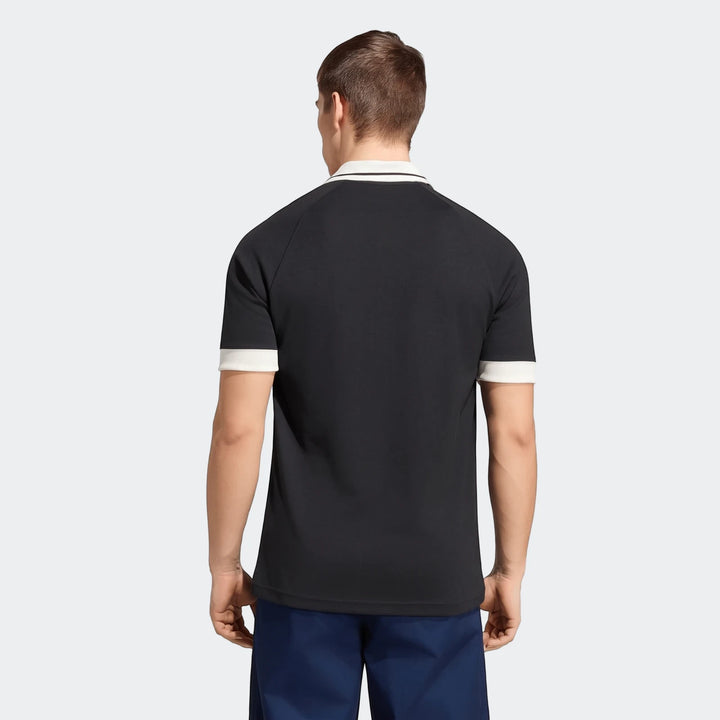 New Zealand Rugby Leisurewear Polo Shirt in black with a white collar and striped cuffs, shown from the back on a male model.