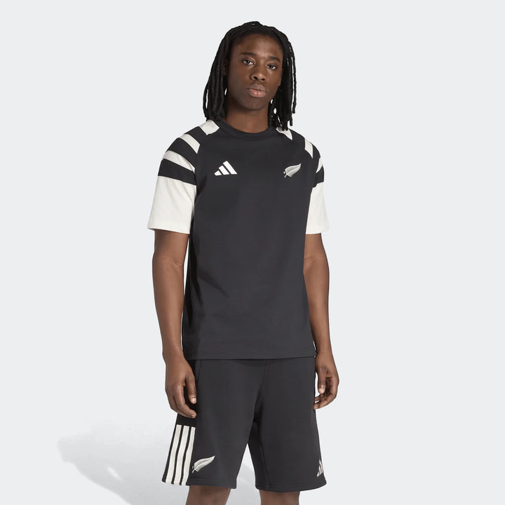 New Zealand Rugby Leisurewear T-Shirt for men, featuring a black design with white accents and logos, worn by a model with