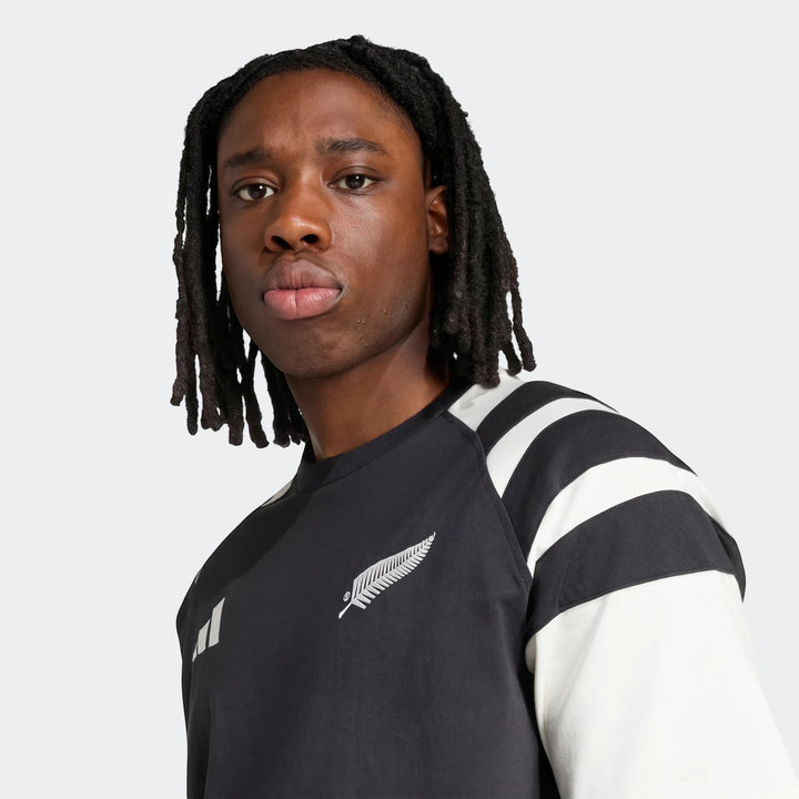 Men's New Zealand Rugby black leisurewear t-shirt featuring white stripes on the sleeve and a silver fern logo on the chest,