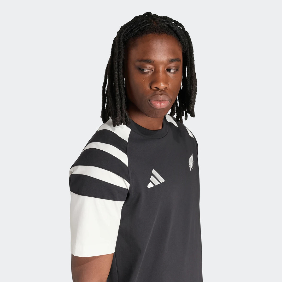 New Zealand Rugby Leisurewear T-Shirt for men, black with white stripes, worn by a model with dreadlocks.