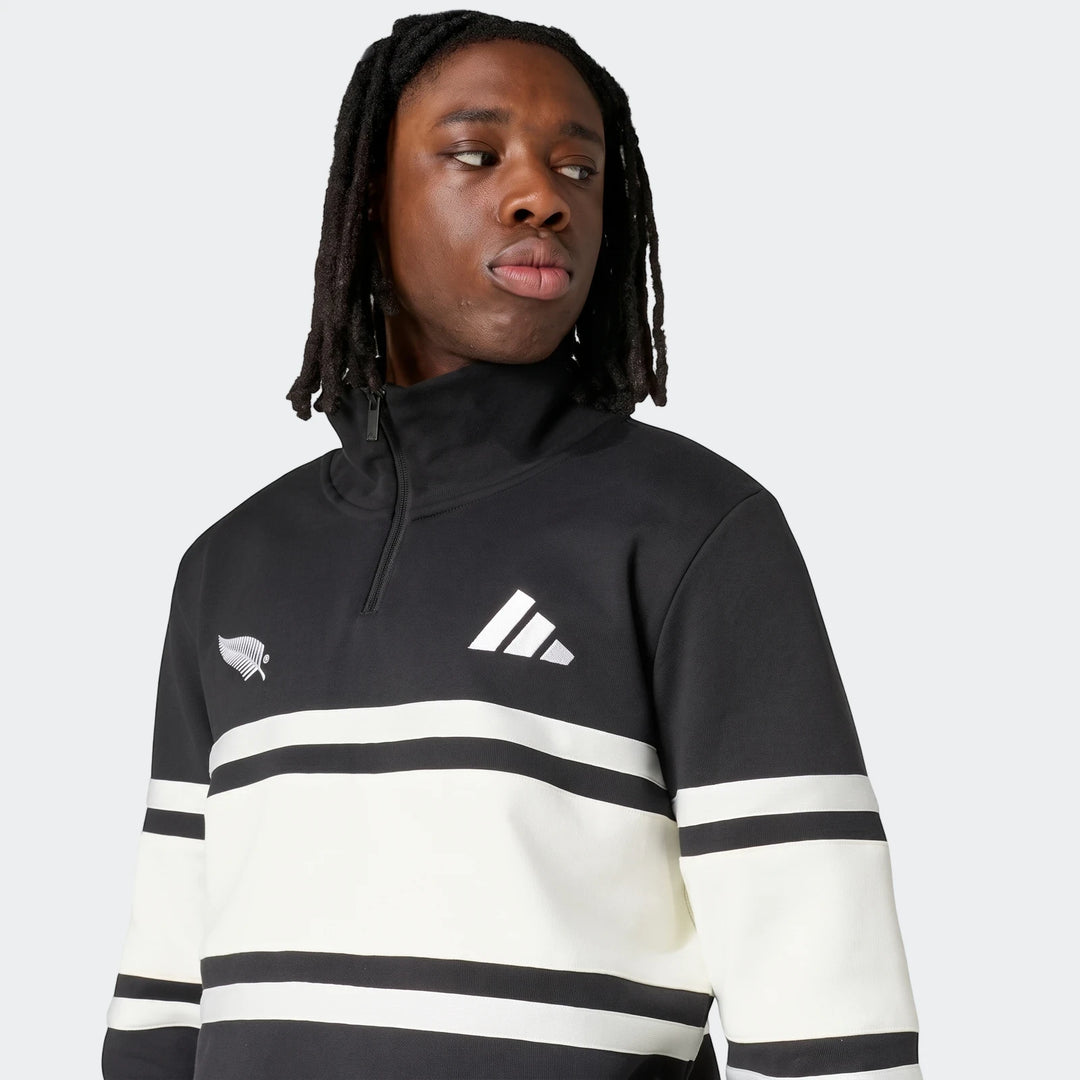 Man wearing a black and white striped New Zealand Rugby Leisurewear Quarter Zip Sweatshirt.