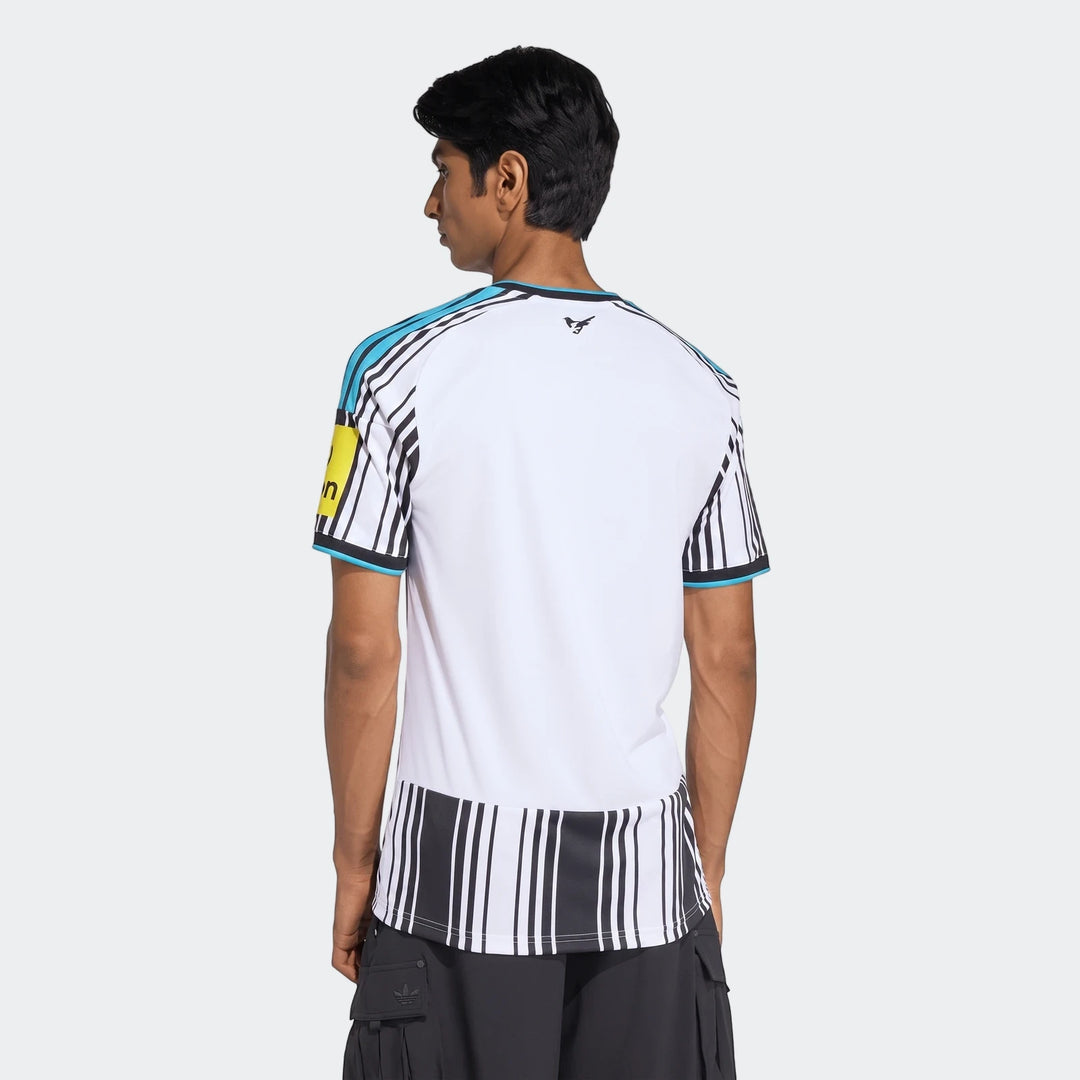 Back view of a male model wearing the white, black, and light blue Newcastle United Fc 26/27 Home Jersey with striped