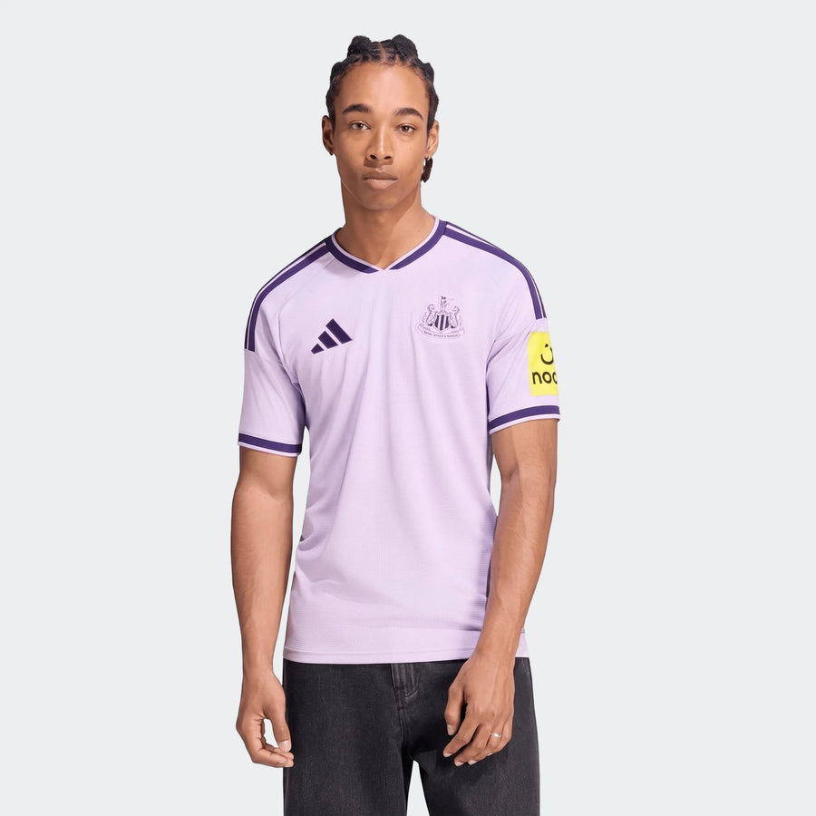 Newcastle United Fc 26/27 Third Jersey in lilac and purple, worn by a male model, front view.